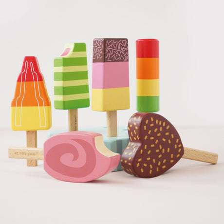 Six wooden play ice lollies/popsicles displayed with their light-blue base on a plain surface.