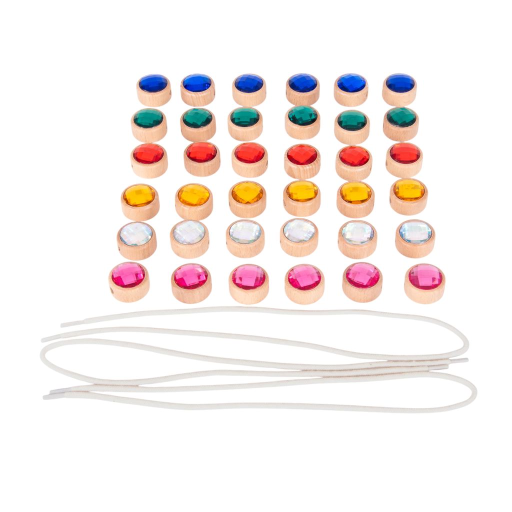 A set of brightly colored wooden gem-shaped beads with holes for threading, designed to develop fine motor skills and hand-eye coordination.