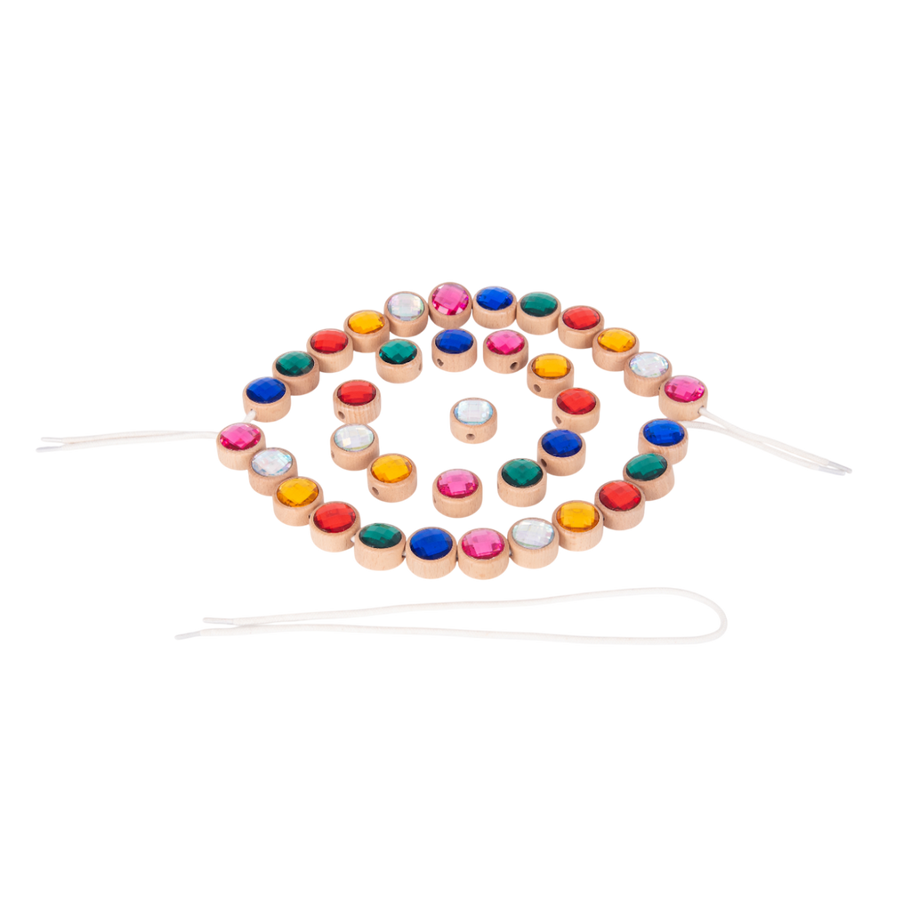 A set of brightly colored wooden gem-shaped beads with holes for threading, designed to develop fine motor skills and hand-eye coordination.