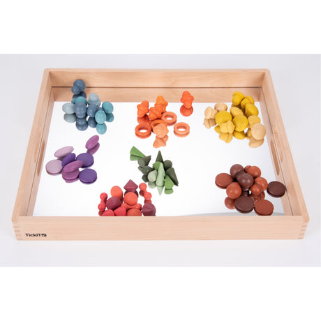 A sturdy wooden tray with a mirrored base, designed to enhance sensory exploration, loose parts play, and visual perception activities.