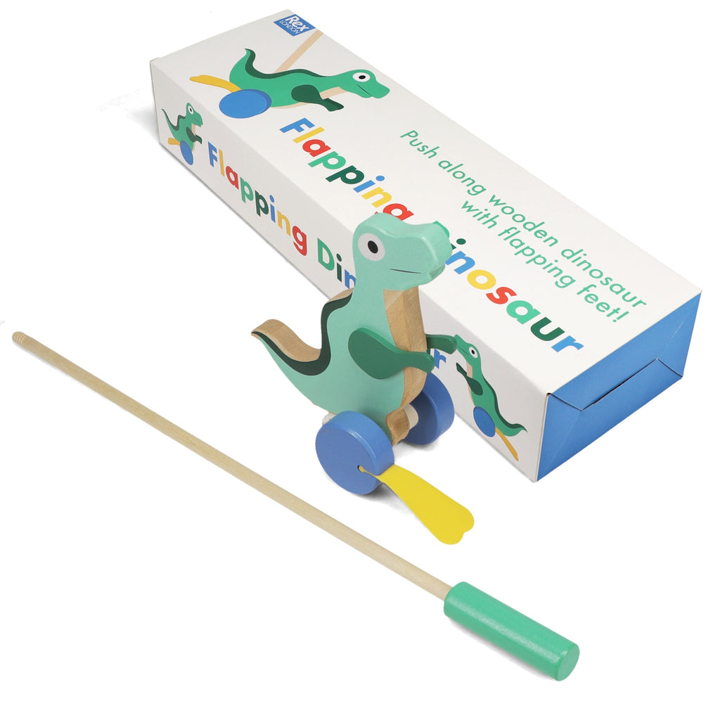 Wooden flapping dinosaur toy with blue wheels, yellow paddles, and a push stick, next to its colorful box.