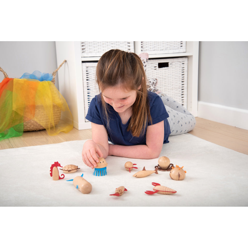 A set of brightly painted wooden marine animals, perfect for imaginative play, storytelling, and early learning activities.