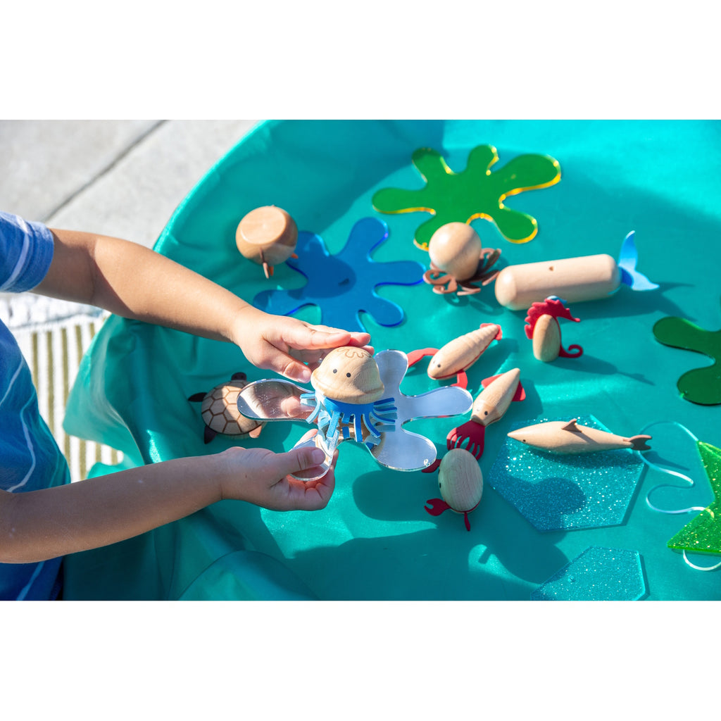 A set of brightly painted wooden marine animals, perfect for imaginative play, storytelling, and early learning activities.