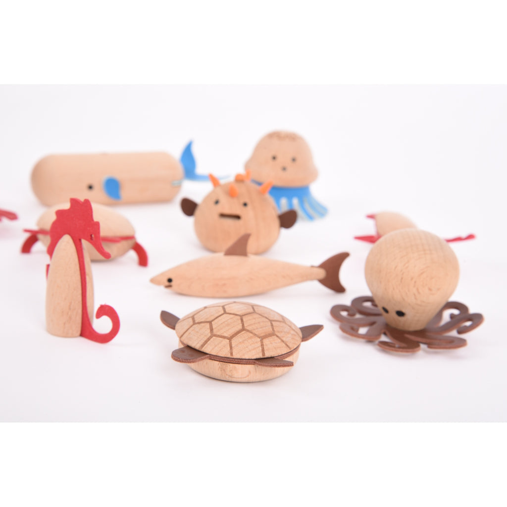 A set of brightly painted wooden marine animals, perfect for imaginative play, storytelling, and early learning activities.