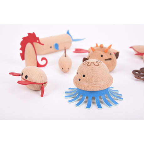 A set of brightly painted wooden marine animals, perfect for imaginative play, storytelling, and early learning activities.
