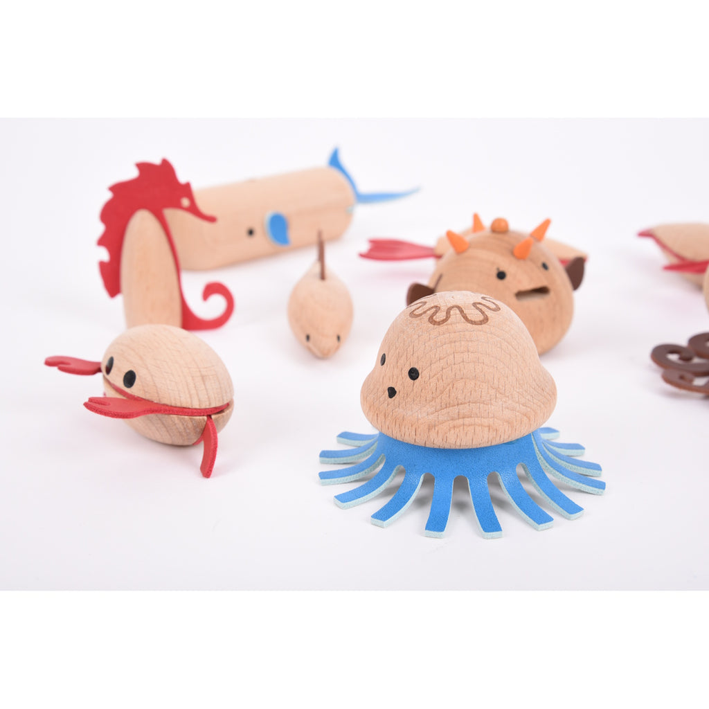 A set of brightly painted wooden marine animals, perfect for imaginative play, storytelling, and early learning activities.