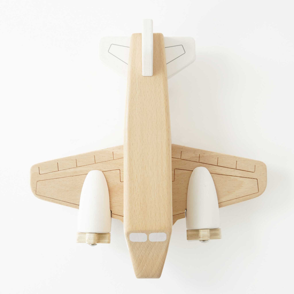Toy wooden airplane with "Le Toy Van Airlines" logo. Made from smooth wood with white details, creating a classic and playful design.