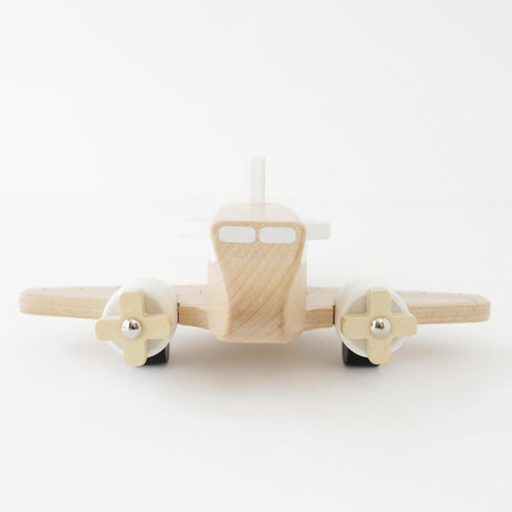 Natural wooden toy airplane with twin propellers, front view on a white background.