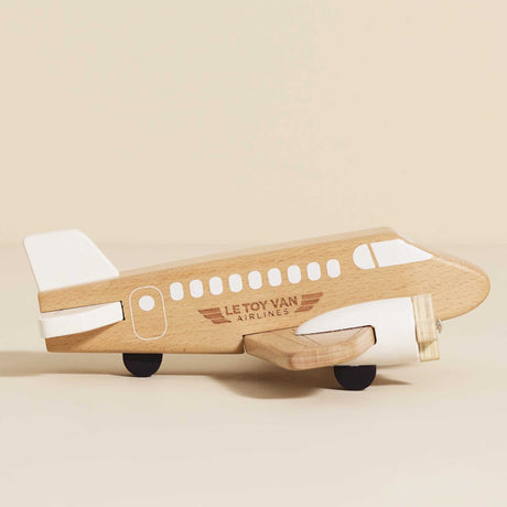 Natural wooden toy airplane with white painted accents and propellers.