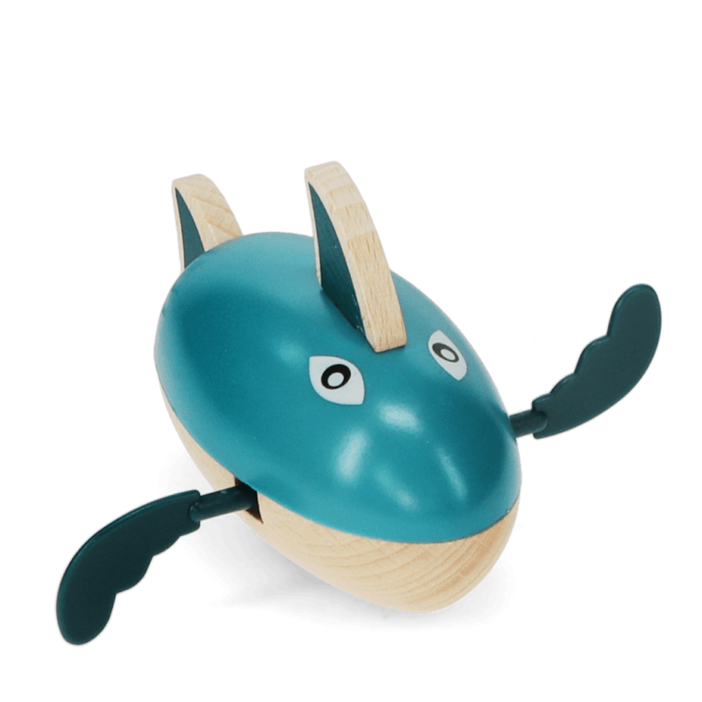 A playful wooden bath toy shaped like a shark that paddles through water when wound up.