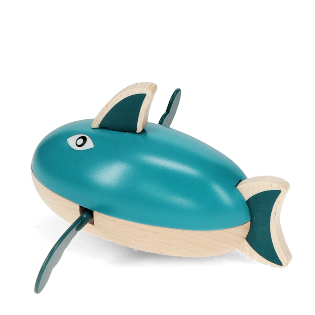 A playful wooden bath toy shaped like a shark that paddles through water when wound up.