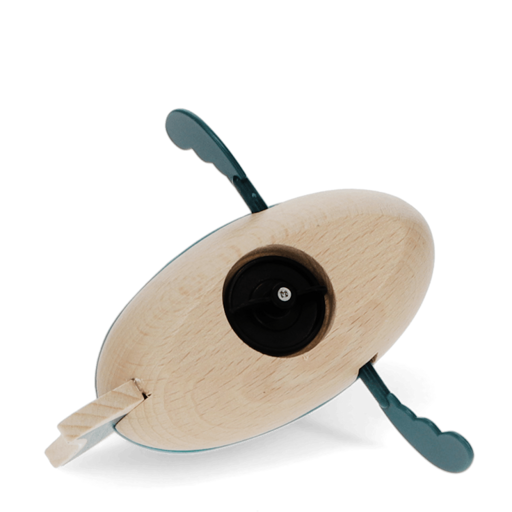 A playful wooden bath toy shaped like a shark that paddles through water when wound up.