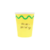 A yellow paper cup featuring a green wavy line and gold script text that reads "Happy Birthday".