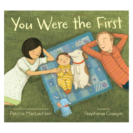 Book cover of "You Were the First" showing a family and dog on a picnic blanket in the grass.