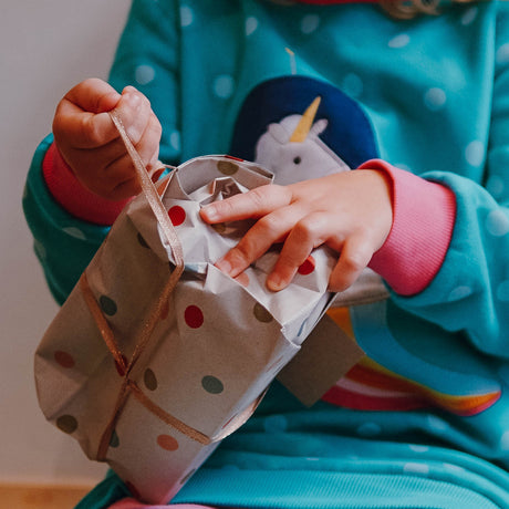Child unwrapping a present
