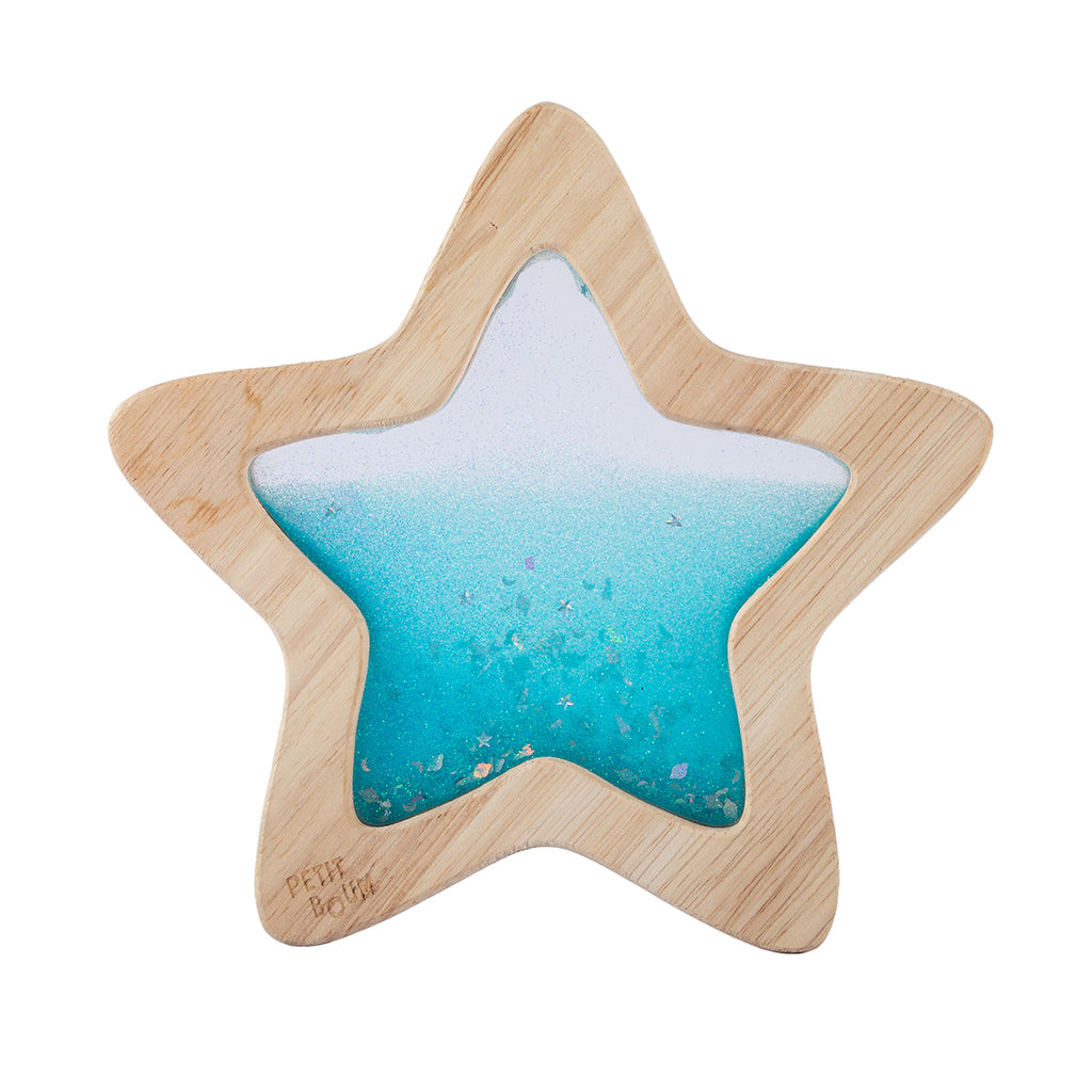A wooden star-shaped sensory toy filled with vibrant blue glittery liquid, designed for visual stimulation.